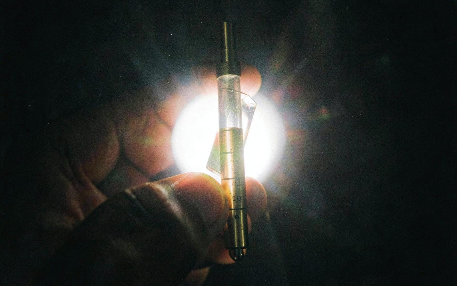 A refractometer held up to a bright light